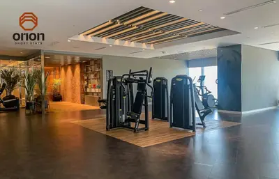 a gym with treadmills and ellipticals in a room at Paramount 2 Bed Apt, Roof Top Bar and Pool overlooking Burj, Triple Balcony, Fully Equipped, Free Toiletries, Full Kitchen, 2 and half Bathrooms, Ground Floor Supermarket, Influencers Haven, Sunrise and Sunset Views over the Sea From All Balcony in Dubai