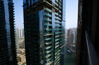 an aerial view of a tall building in a city at LUXURY 1 BR Apartment at Marina Gate Jumeirah Living in Dubai