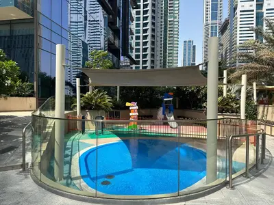 a swimming pool in a city with tall buildings at LUXURY 1 BR Apartment at Marina Gate Jumeirah Living in Dubai
