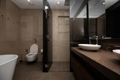 a bathroom with two sinks and a toilet and a tub at LUXURY 1 BR Apartment at Marina Gate Jumeirah Living in Dubai