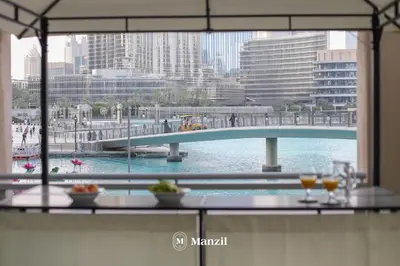 a view of a bridge over a river from a window at Manzil - Luxury 3BR Villa w/ maid room, Full Burj & Fountain view in Dubai