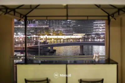 a view of a bridge at night from a window at Manzil - Luxury 3BR Villa w/ maid room, Full Burj & Fountain view in Dubai