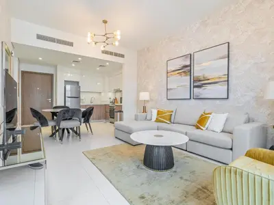 a living room with a couch and a table at Fantastic 1 BR in Park Point - Dubai Hills in Dubai