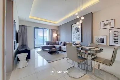 a living room with a table and a couch at Manzil - Ultra Luxury 1BR apartment Paramount Tower with Burj Khalifa and Downtown Views in Dubai