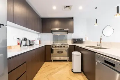a kitchen with a stove and a sink at Ultra Luxury Wasl 1 Residences Zabeel Park in Dubai