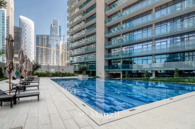 a swimming pool in front of a building at Elegant 3BR in a Prime Location Near Metro, Business Bay in Dubai