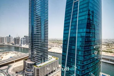 a view of two tall skyscrapers in a city at Elegant 3BR in a Prime Location Near Metro, Business Bay in Dubai
