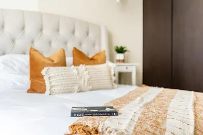 a bedroom with a large bed with two books on it at Elegant 3BR in a Prime Location Near Metro, Business Bay in Dubai