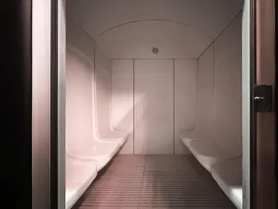 a bathroom with two white urinals and a corridor at Trophy - Urban Oasis Suite in Dubai
