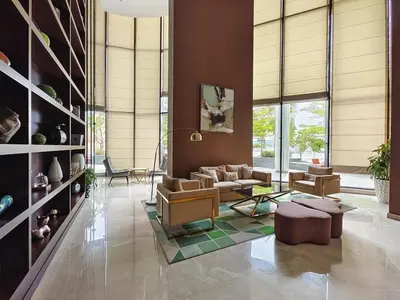 a living room with couches and chairs and windows at Elegant Apartment Amidst Vibrant Area With Balcony in Dubai