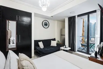 a bedroom with a bed and a couch at Cozy JLT Studio Lakeview Pool Metro Access in Dubai