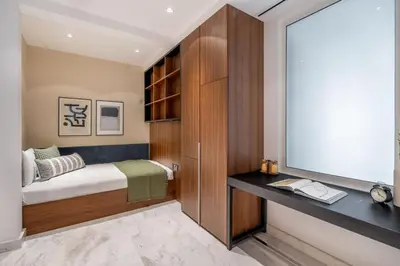 a small bedroom with a bed and a tv at GuestReady - Beachfront heaven with stunning views in Dubai