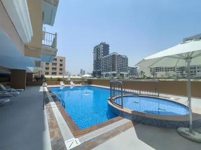 a swimming pool on the roof of a building at Spacious Serene Studio Retreat in JVC by Suiteable in Dubai