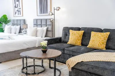a living room with a couch and a coffee table at Spacious Serene Studio Retreat in JVC by Suiteable in Dubai