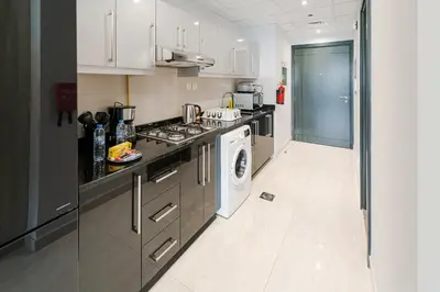 a kitchen with a stove and a washing machine at Burj Khalifa View I Near to Dubai Mall in Dubai