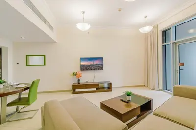 a living room with a couch and a table at RH- Spacious, Stylish, 01BR near Mall of Emirates in Dubai
