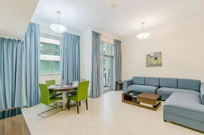 a living room with a couch and a table at RH- Huge, Comfortable 01 BR Apartment in Barsha1 in Dubai