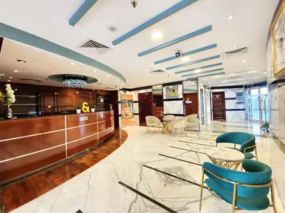a lobby of a hotel with chairs and a bar at RH- Huge, Comfortable 01 BR Apartment in Barsha1 in Dubai