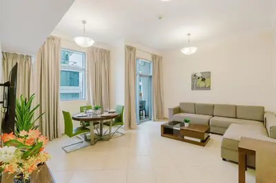 a living room with a couch and a table at RH- Huge, Comfortable 01 BR Apartment in Barsha1 in Dubai
