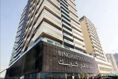 a building with a sign that reads birmingham crisis college at Polished 1BR at Binghatti Creek Al Jadaf by Deluxe Holiday Homes in Dubai