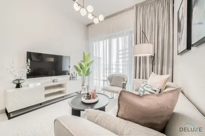 a living room with a couch and a tv at Polished 1BR at Binghatti Creek Al Jadaf by Deluxe Holiday Homes in Dubai