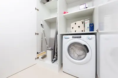 a laundry room with a washer and dryer at BRAND-NEW 1 Bedroom with full Marina View in Dubai
