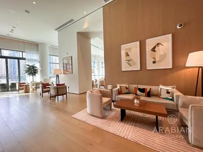 a living room with a couch and chairs and a table at BRAND-NEW 1 Bedroom with full Marina View in Dubai