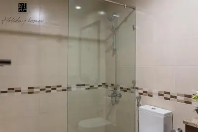 a bathroom with a glass shower with a toilet at Mira Holiday Homes - Beautiful Studio in Living Legends in Dubai
