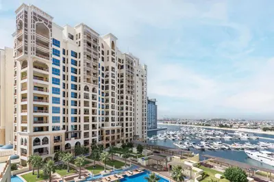 an aerial view of a large apartment building with a marina at Marina Residences 2BR: Seaside in Palm Jumeirah in Dubai