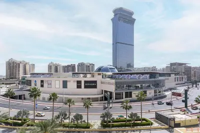 a building with a tall tower in a city at Marina Residences 2BR: Seaside in Palm Jumeirah in Dubai