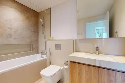 a bathroom with a toilet and a sink and a tub at Vacationer l 1 Bedroom on Low Floor l Close to Burj Khalifa l Pool Access & Free Wi-Fi in Dubai