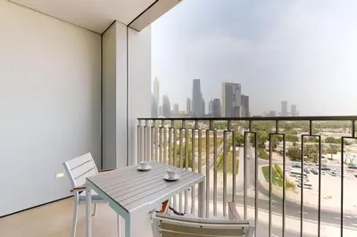 a table and chairs on a balcony with a view of the city at Vacationer l 1 Bedroom on Low Floor l Close to Burj Khalifa l Pool Access & Free Wi-Fi in Dubai