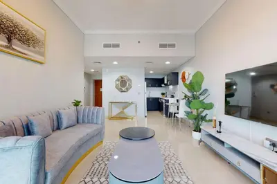 a living room with a couch and a table at Ocean Heights - Gorgeous One Bedroom in Dubai