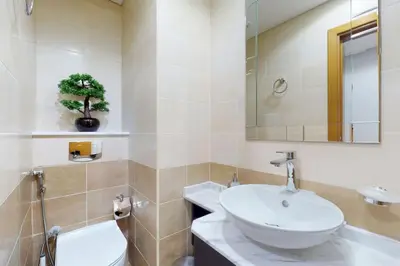 a bathroom with a sink and a toilet and a mirror at Ocean Heights - Gorgeous One Bedroom in Dubai