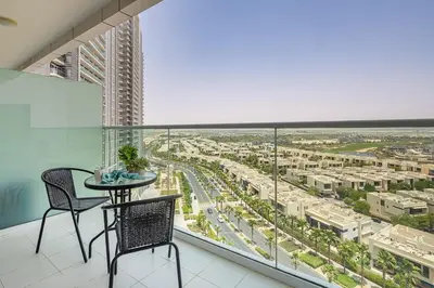 a balcony with a table and chairs and a city at Frank Porter - Carson A in Dubai