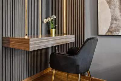 a black chair sitting in front of a wooden table at Luxury studio at JLT near metro in Dubai