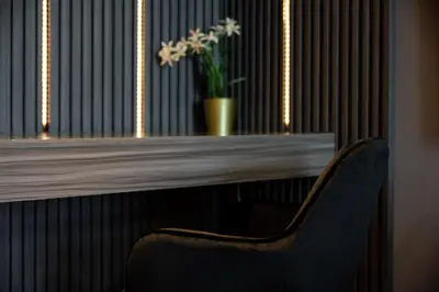 a chair sitting in front of a table with a plant at Luxury studio at JLT near metro in Dubai