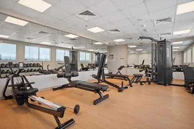 a gym with several treadmills and exercise bikes at Stylish studio at Sports City in Dubai