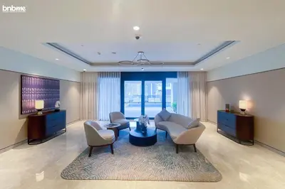 a living room with a couch and chairs and a table at bnbme - Luxury 1BR Apt w Burj Khalifa Views Pool Gym & Prime Location Near Dubai Mall in Dubai