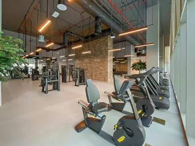 a gym with rows of treadmills and elliptical machines at Silkhaus Opera district in Downtown new tower with pool & gym in Dubai