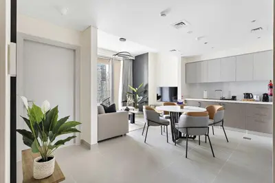 a kitchen and living room with a table and chairs at Silkhaus Opera district in Downtown new tower with pool & gym in Dubai