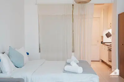 a bedroom with a large bed with white pillows at Stunning Palm Views Apt on the beach Dubai in Dubai