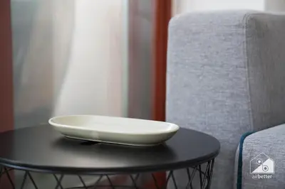 a white bowl on a table next to a chair at Stunning Palm Views Apt on the beach Dubai in Dubai