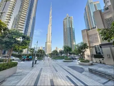 a street in a city with tall buildings at Vogue Downtown Act Two near Burj Khalifa and Dubai Mall, Three Bedroom Plus Kids room Apartment with Balcony and Burj Khalifa View, Access to all Amenities in Dubai