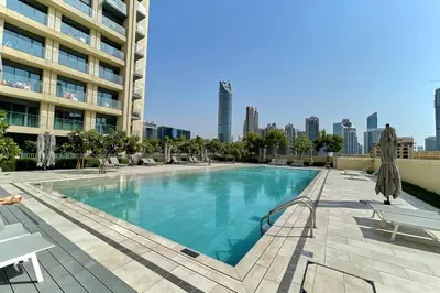 a swimming pool on the roof of a building at FIRST CLASS 2BD, Full Burj Khalifa view in the Heart of Downtown in Dubai
