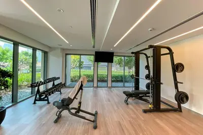 a gym with several treadmills and a flat screen tv at FIRST CLASS 2BD, Full Burj Khalifa view in the Heart of Downtown in Dubai