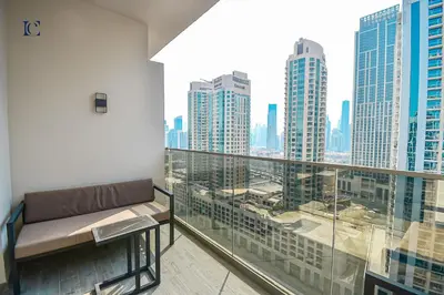 a balcony with a couch and a view of the city at Luxury Escapes - Large & Brand New Studio Apt Business Bay - MAG in Dubai