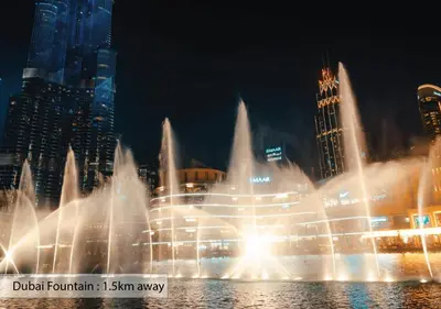 a water fountain in front of a city at night at Luxury Escapes - Large & Brand New Studio Apt Business Bay - MAG in Dubai