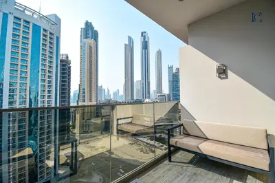 a balcony with a view of a city skyline at Luxury Escapes - Large & Brand New Studio Apt Business Bay - MAG in Dubai