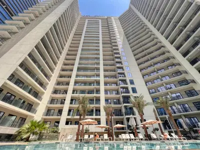 a large apartment building with a pool in front of it at Quasi-Hotels Zada Cozy Lux in Business Bay 1BR in Dubai
